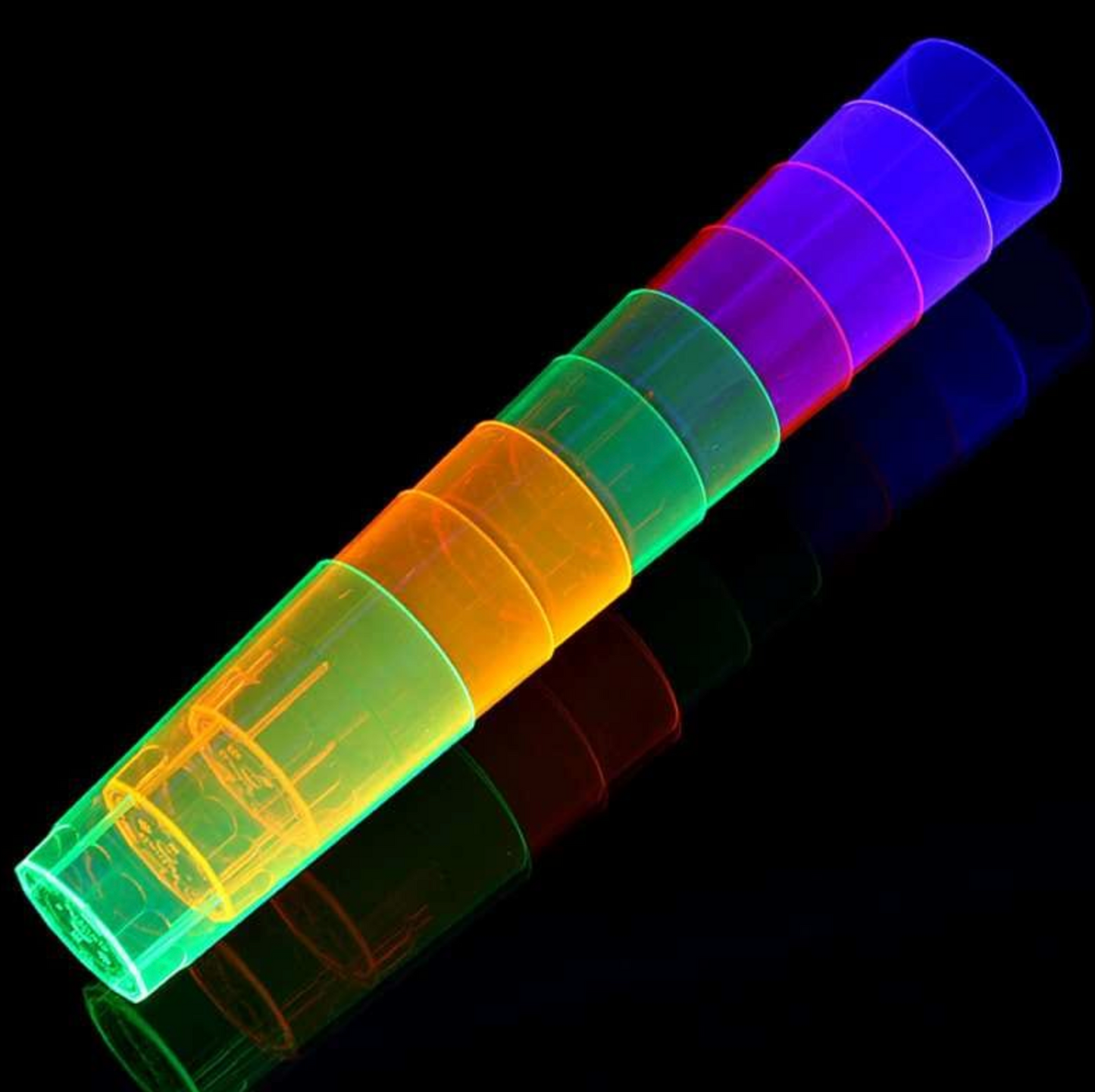 Mehrfarbige UV Leuchtbecher für Party in einer Reihe auf schwarzem Hintergrund